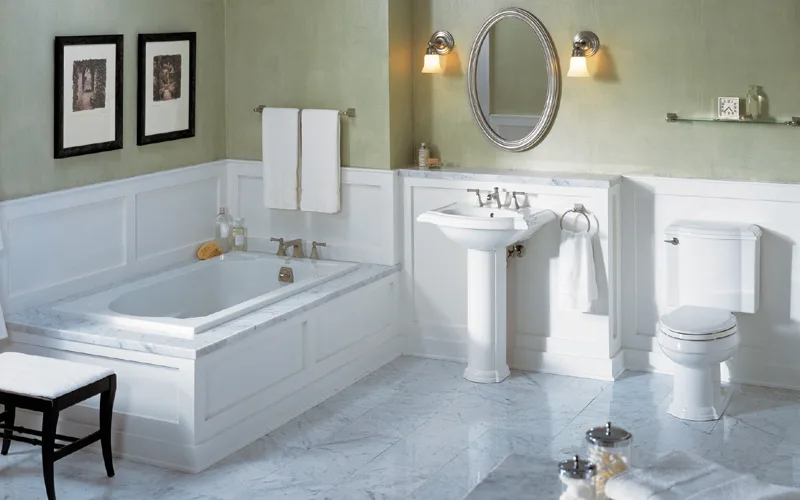 Classic white bathroom with wainscoting and a soaker tub