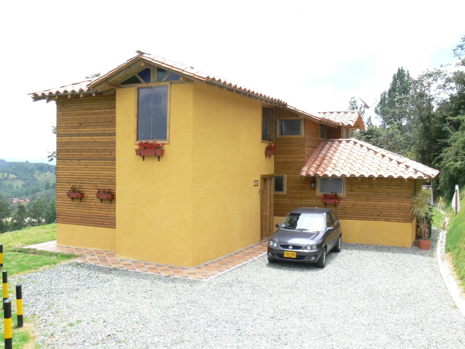 Yellow stucco cottage with timber trim