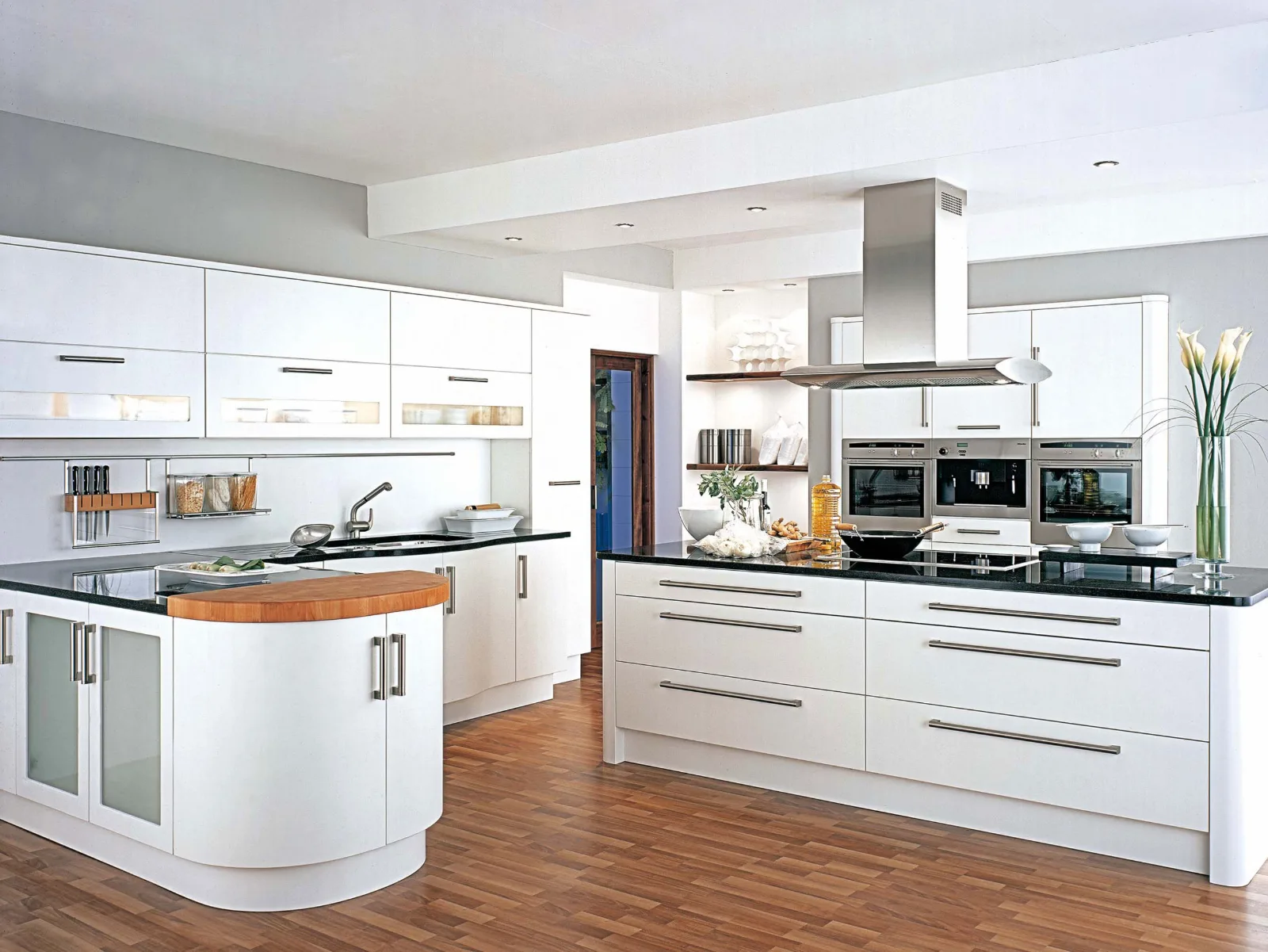 Modern white kitchen with a large island and hardwood floor