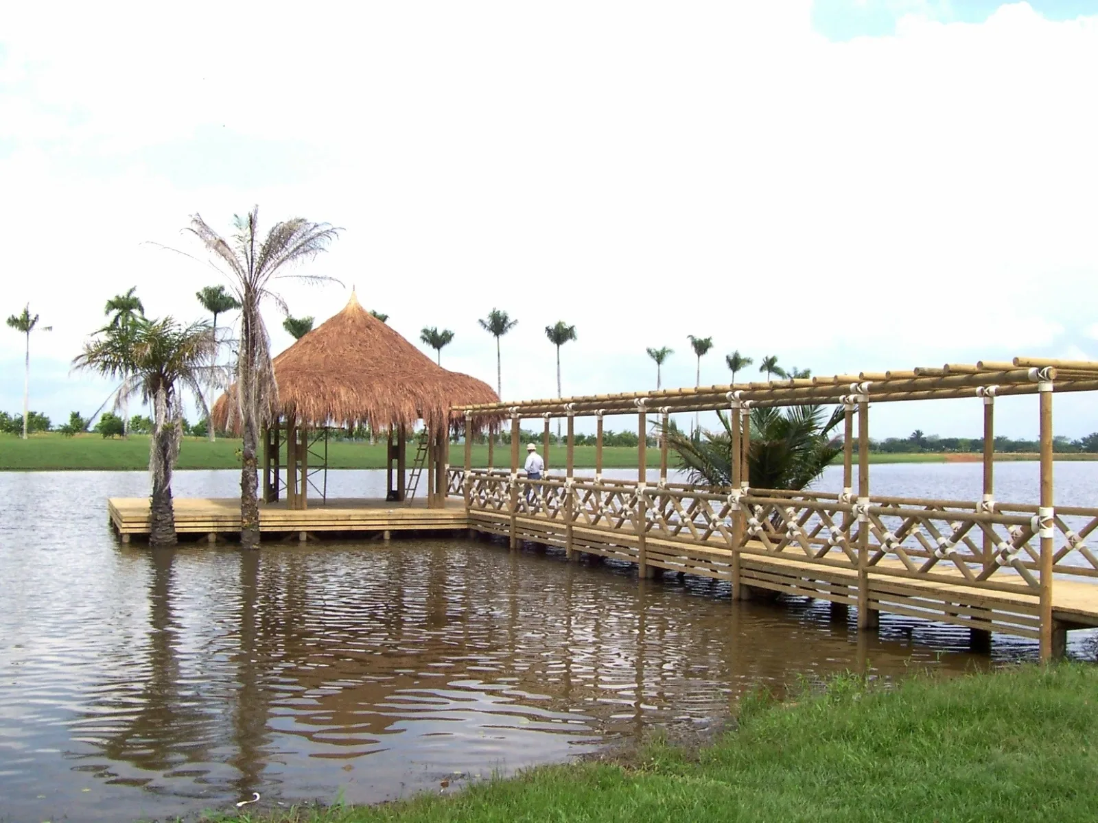 Lakeside wooden dock with a thatched kiosko