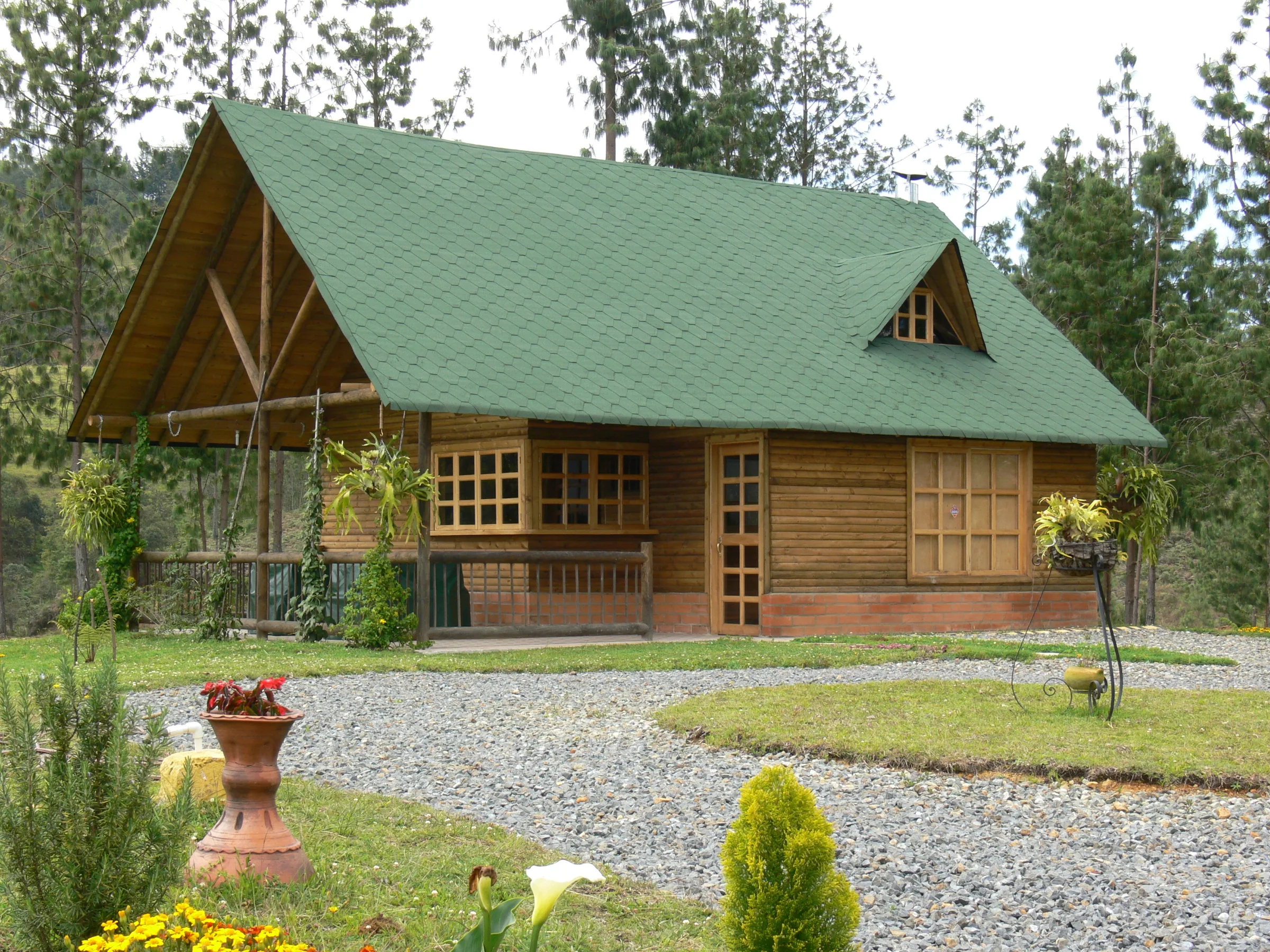 Timber cottage with a green roof on a lawn