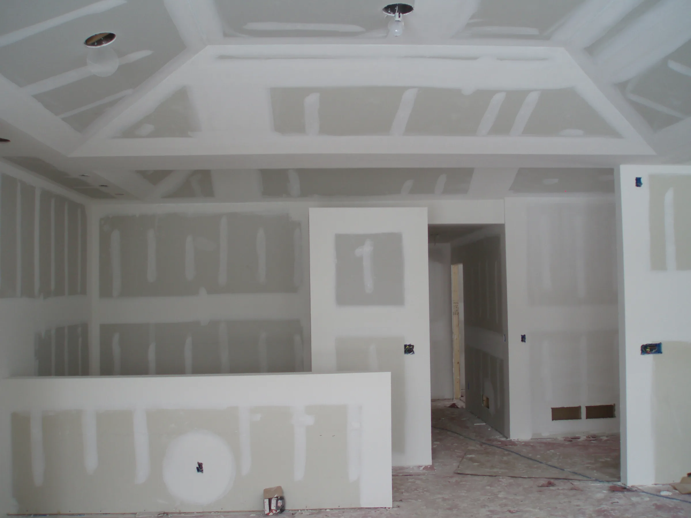 Drywall taping and plastering in progress