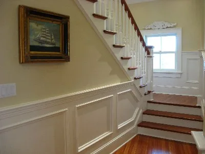 Staircase with wainscoting and hardwood treads